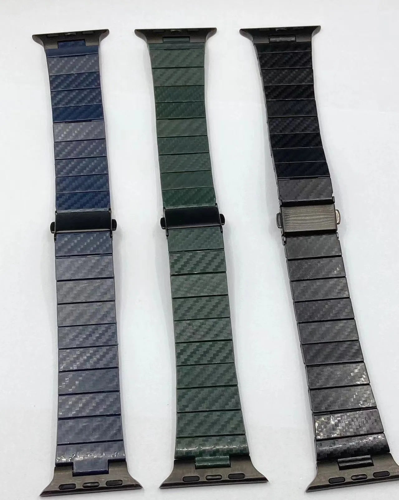 Black carbon fiber watch band for Apple Watch showing chain links and metal clasp on a white background