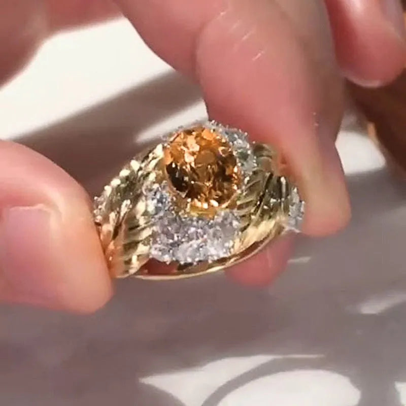Gold-coloured embossed feather ring for women with an inlaid yellow zircon stone.