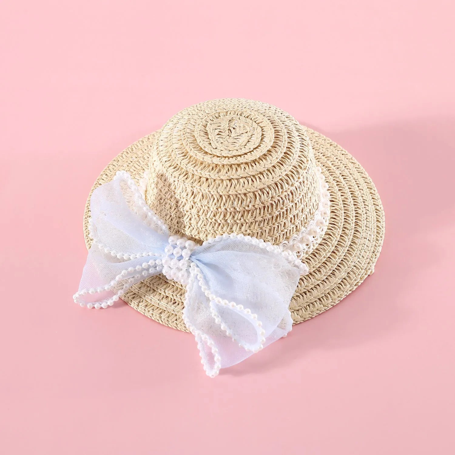 Pet cat wearing princess-style straw hat with woven pearl bow decoration in lafite leaves material