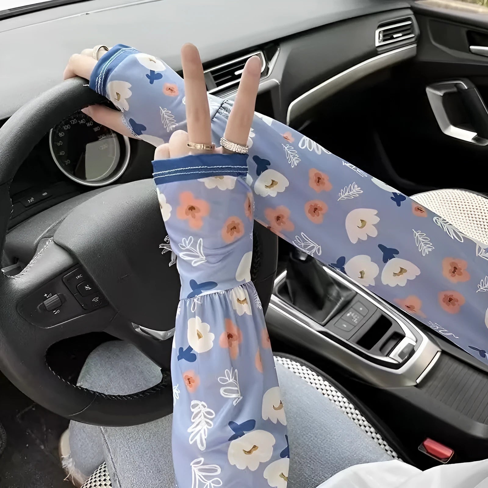 Printed viscose fibre sun protection oversleeves in floral design with elasticated cuffs.