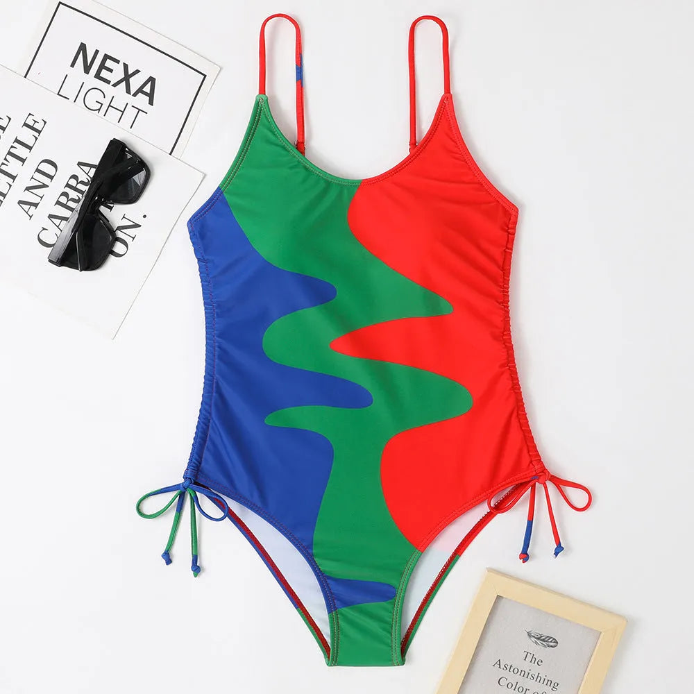 Blue women's sleeveless backless one-piece swimsuit with a striped print, made from polyester and nylon fabric.