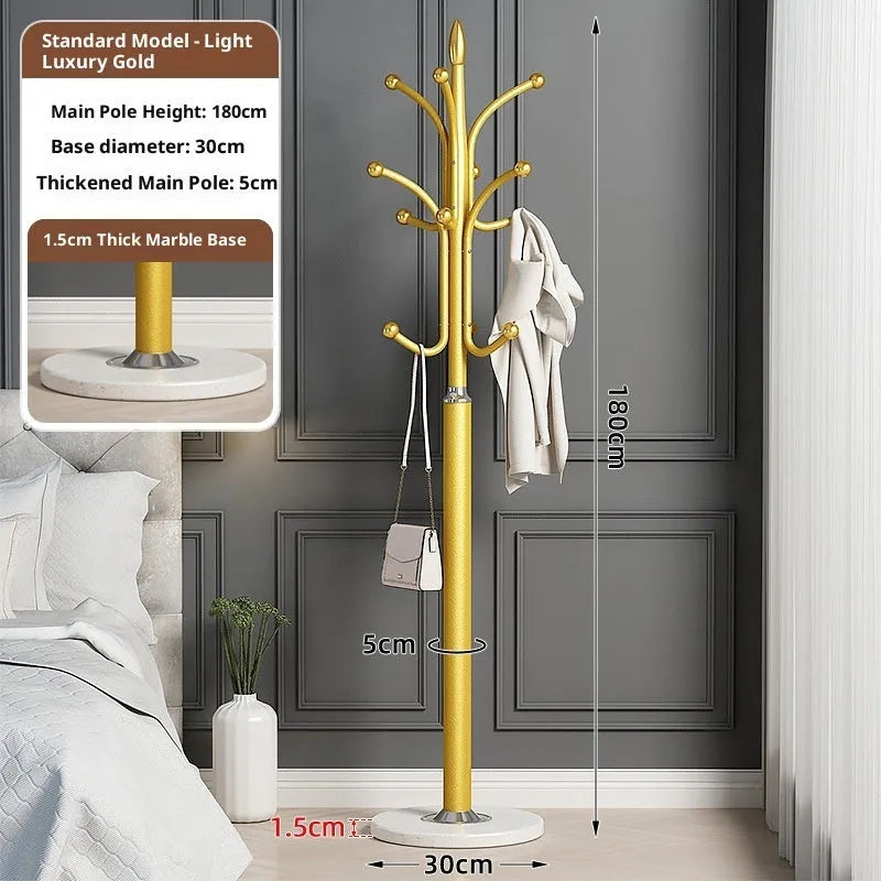 Floor-standing iron coat rack in black with vertical metal frame for hanging jackets and bags in a bedroom or hallway