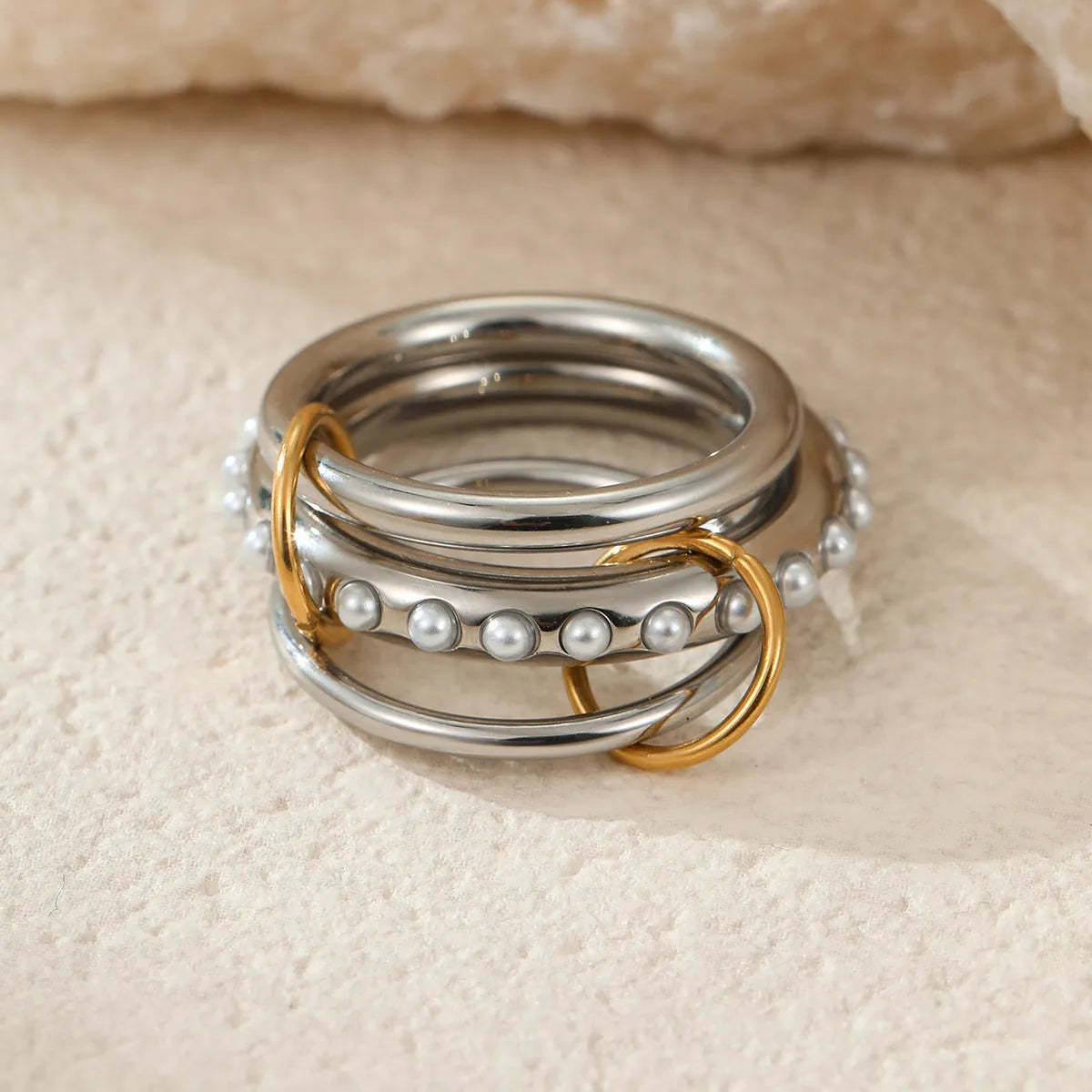Gold plated exaggerated stackable ring for women on a hand, showing layered jewellery style.