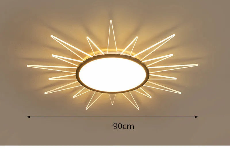 Modern round aluminium LED ceiling lamp with remote control on a white ceiling.