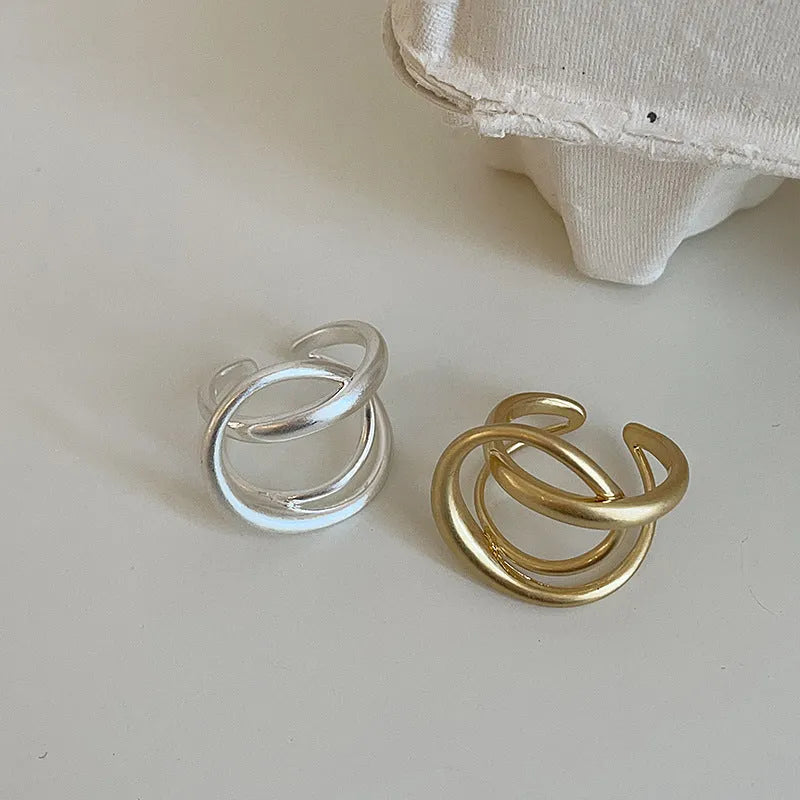 Geometric open ring with three-dimensional interlaced design in matte metal finish