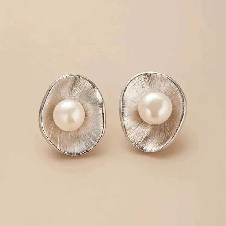 Pearl sterling silver needle earrings with geometric design and gold electroplated finish