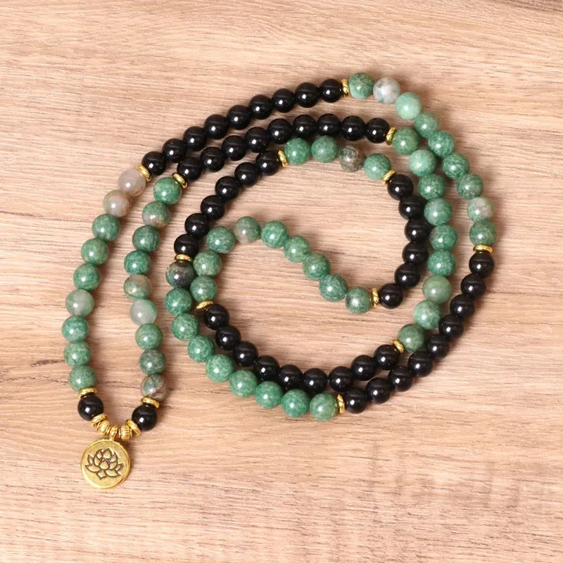 Women's green and black alloy elastic beaded bracelet on a wrist, showing natural style design.