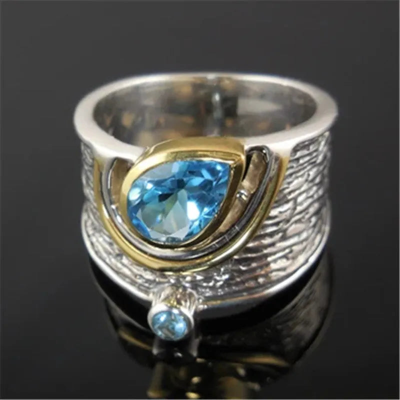 Blue zircon Chinese style women's ring with drop shape and rhinestone detailing on alloy band