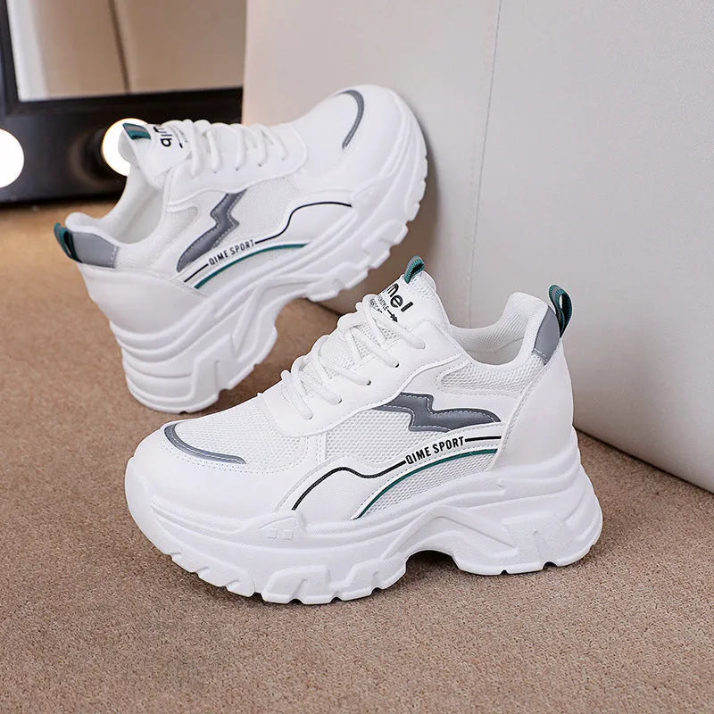 Women's beige and white height increasing dad shoes with mesh upper and cross shoulder straps.