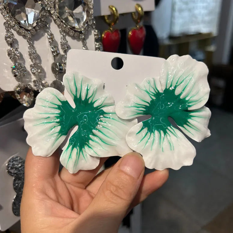Close-up of pastoral style alloy flower stud earrings with oil-spot glaze in blue, green, purple, and rose colours