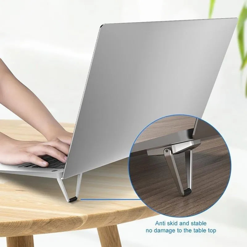 Compact folding aluminium laptop stand bracket in silver with adhesive strips