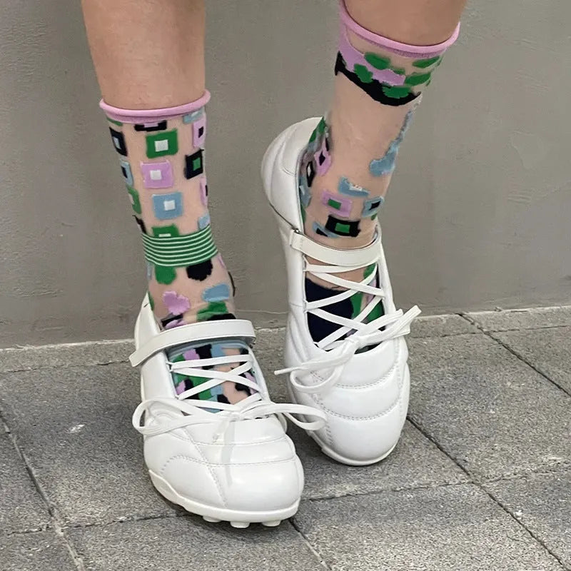 Women's silver lace-up sports shoes with a decorative bow on the front.