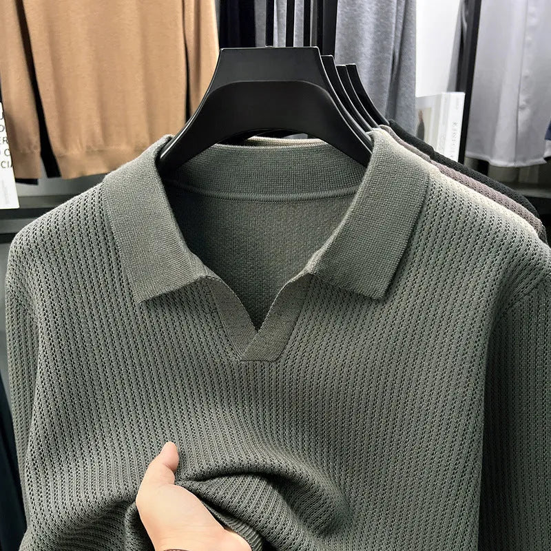 A man's loose-fitting casual pullover jumper in a neutral colour, shown on a model.