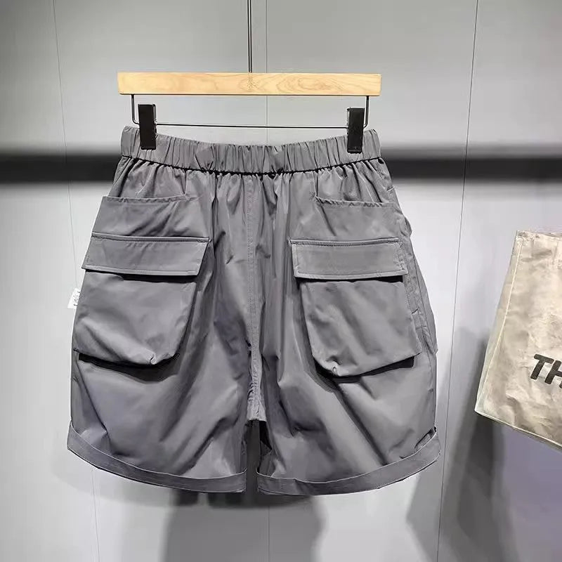 Men's loose-fitting black workwear shorts with pockets, featuring a non-iron finish and a mid-waist design.