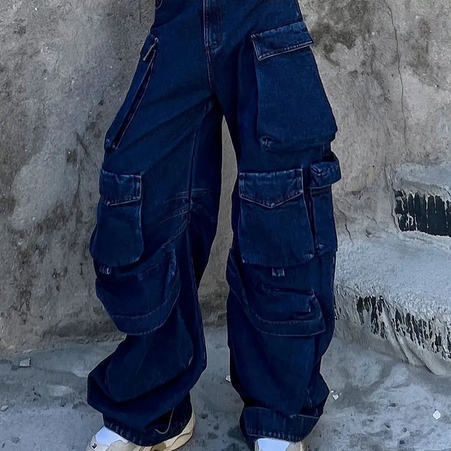 Dark blue distressed wide-leg high-waist jeans with multiple pockets on a denim background.