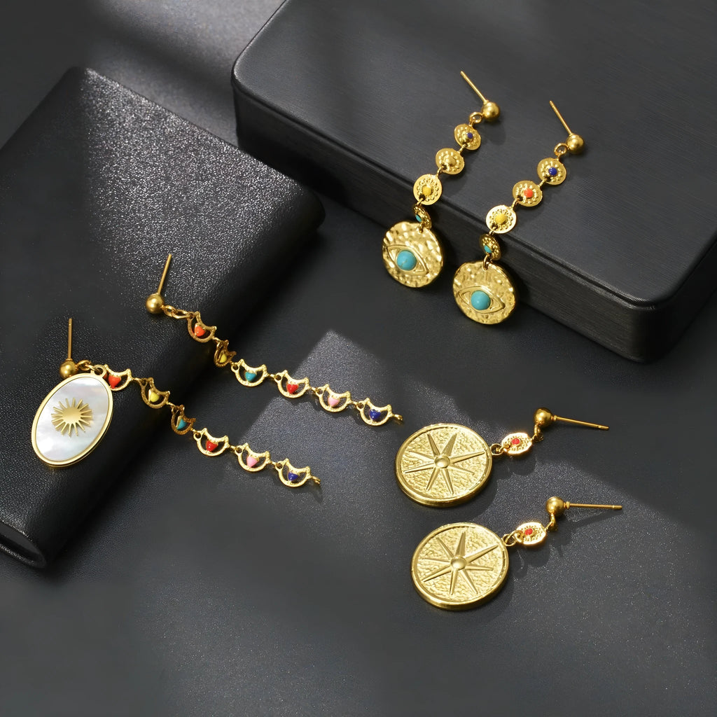 Geometric stainless steel earrings showing eight awn star, eye, and shell sun design variations