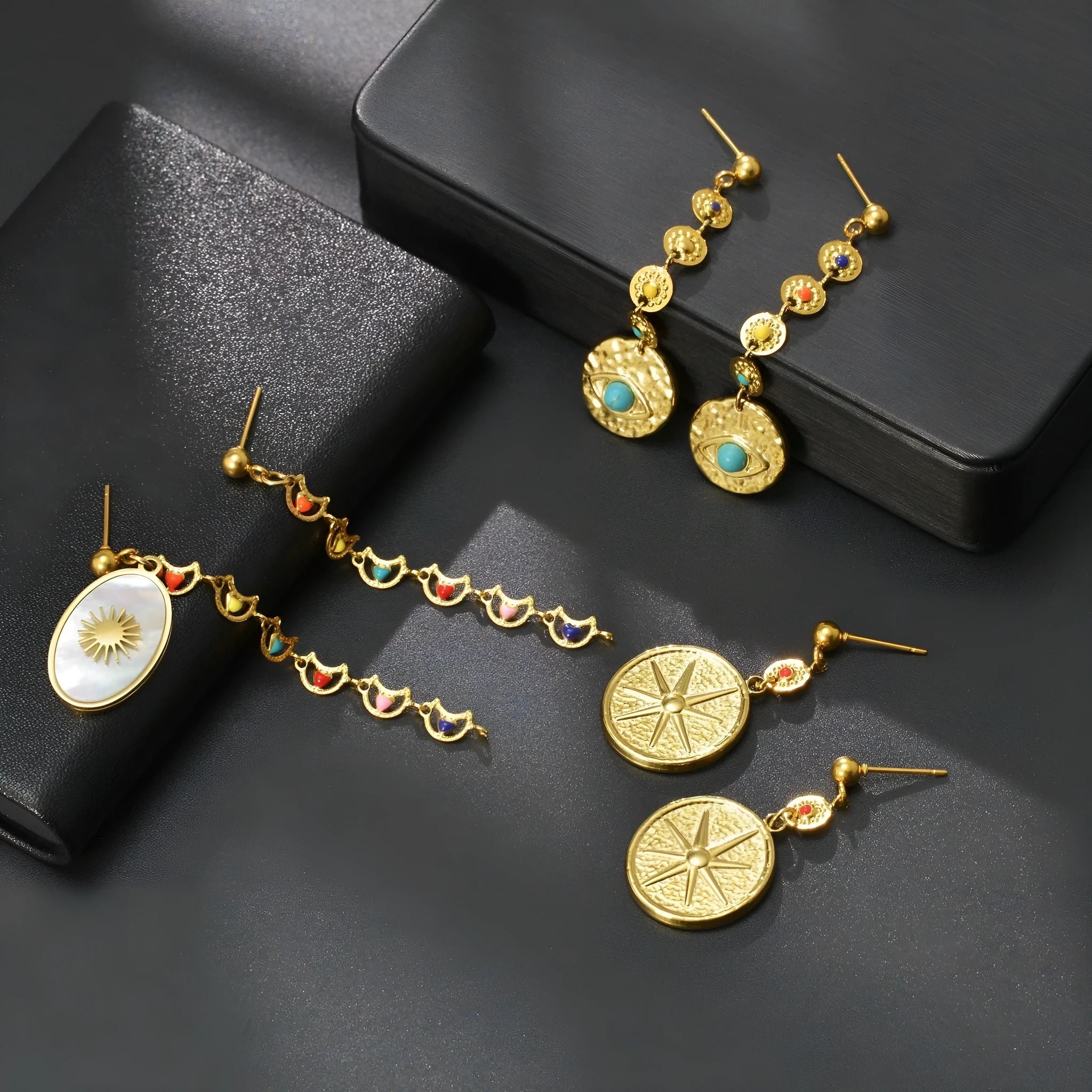 Geometric stainless steel earrings showing eight awn star, eye, and shell sun design variations