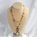 Two-layer tribal necklace with stone and glass pendants on a chain, shown in beige and blue.