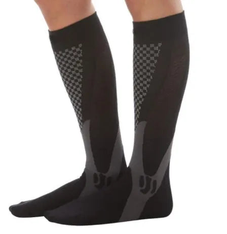 Graduated compression socks for men and women in black, shown laid flat.