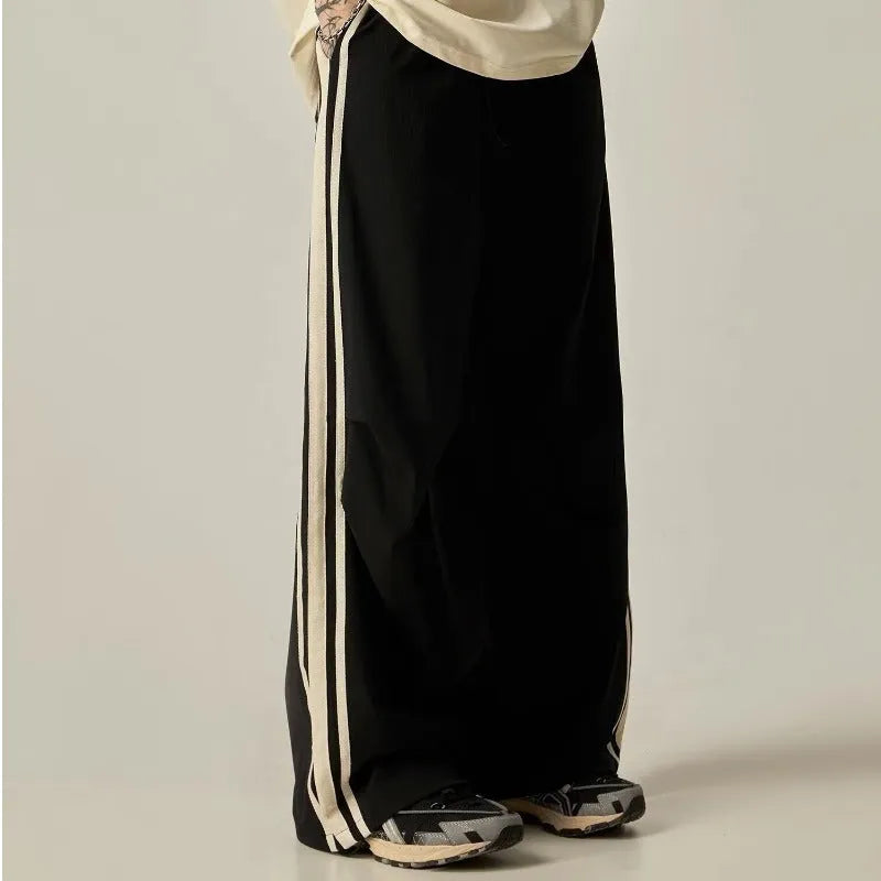 Black high-waisted wide-leg polyester climbing trousers for men laid flat.