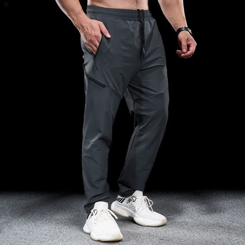 Men's nylon workout pants in mid-waist cut with quick-drying properties for sports and fitness