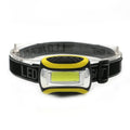 Yellow plastic headlamp with adjustable strap and COB light lens for outdoor use.