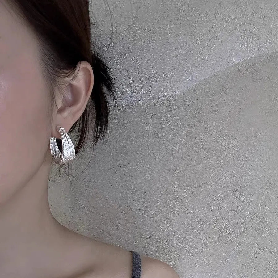 Geometric copper stud and clip earrings in gold and silver electroplated colours with simple multi-layer design