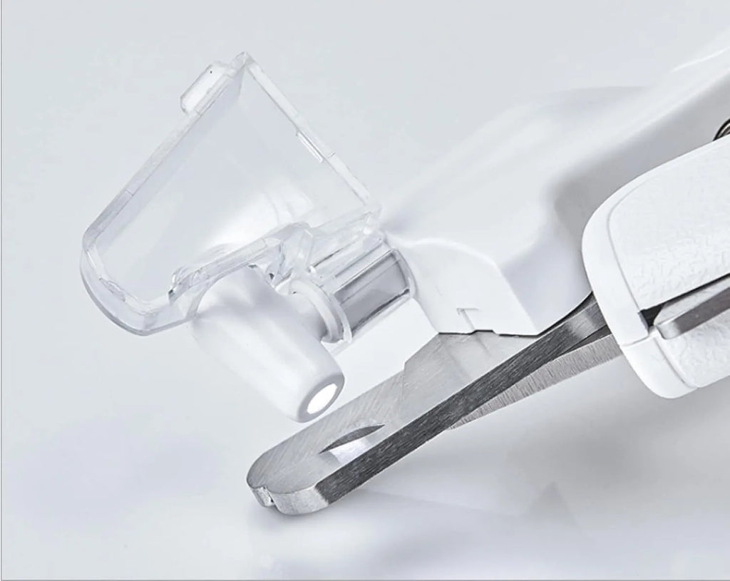White pet nail clippers with LED light, transparent guard, and nail file for cats and dogs