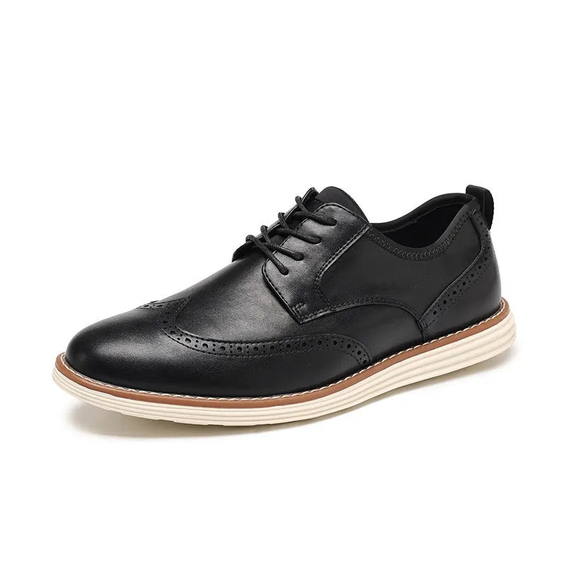 Men's black slip-on business casual shoes with round toe and carved sole detail on a white background.