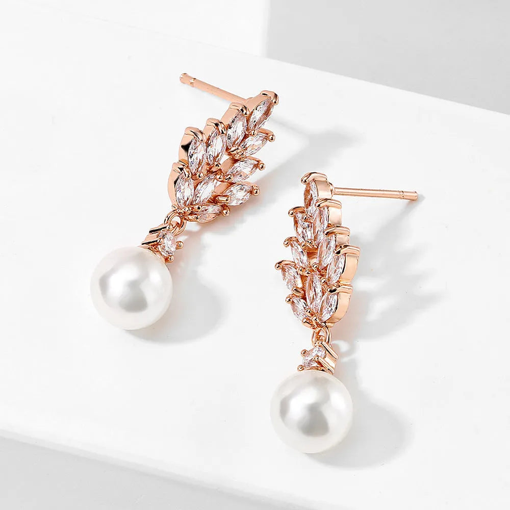 Geometric shaped floral earrings with micro zircon inlays, shown in a gold-tone plated finish.