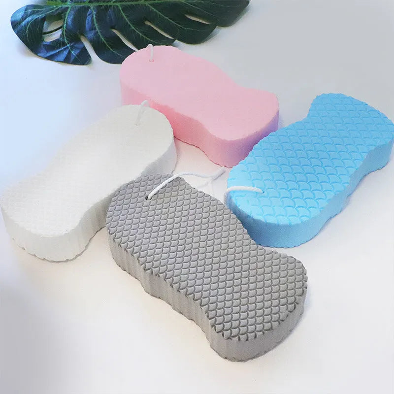 White 3D fish scale pattern bath sponge ball for gentle exfoliation in the shower.