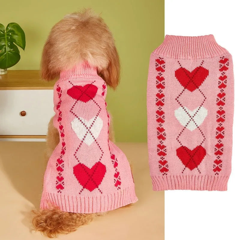Small dog wearing a pink acrylic sweater with a bow and love heart design in ins style