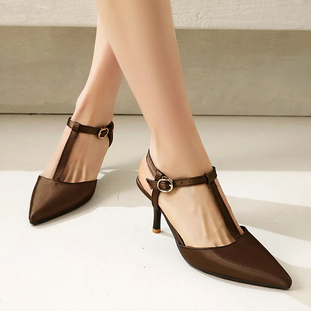 Women's pointed T-strap high heels in top grain leather, black colour, side view on plain background