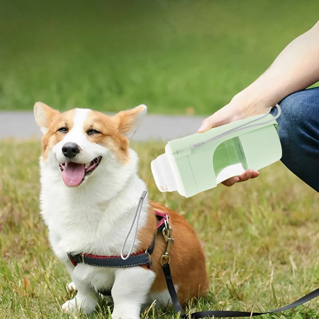 Green 2-in-1 travel dog water bottle and feeder with lanyard, showing folded size.