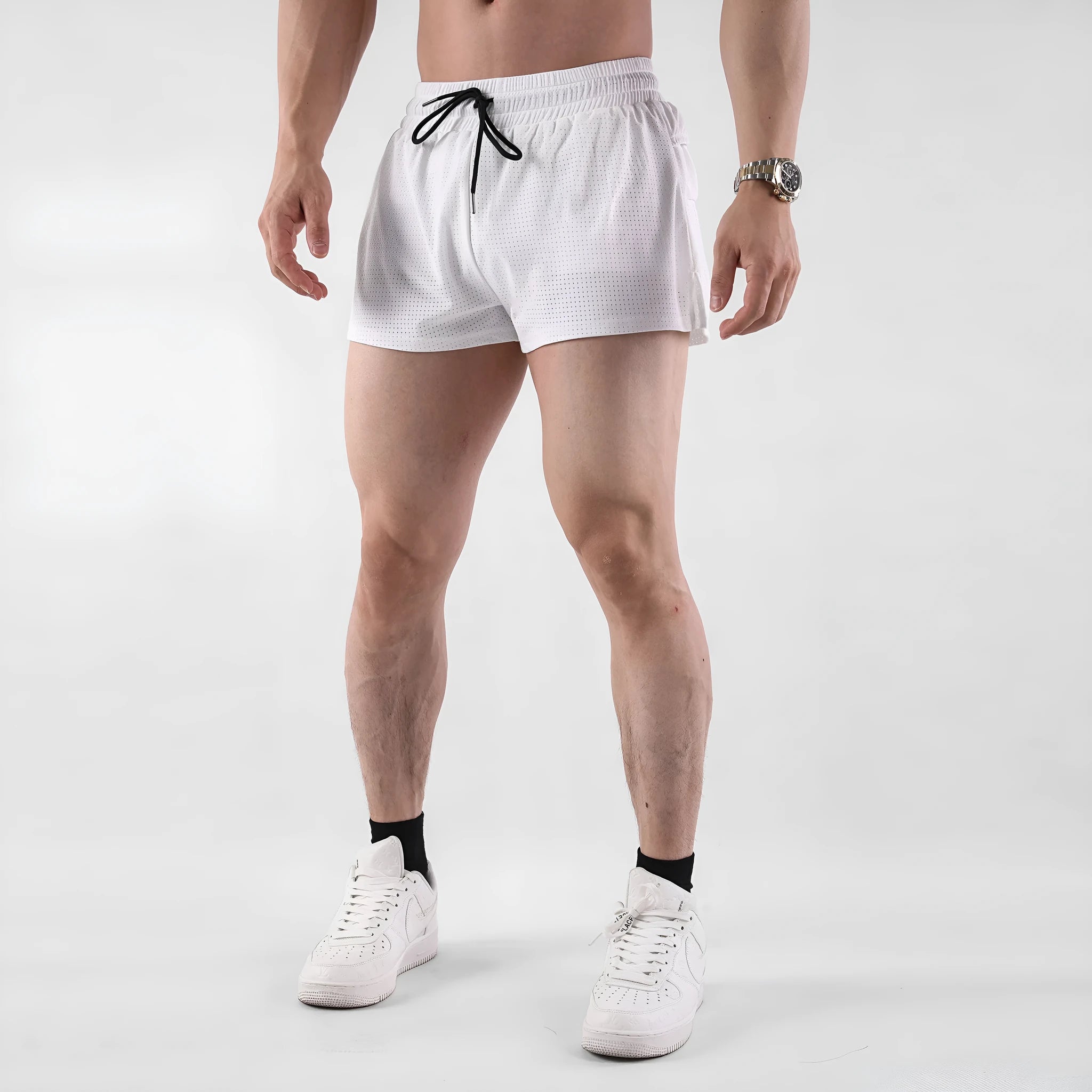 Men's white and black quick-drying nylon sports shorts on a size chart background.
