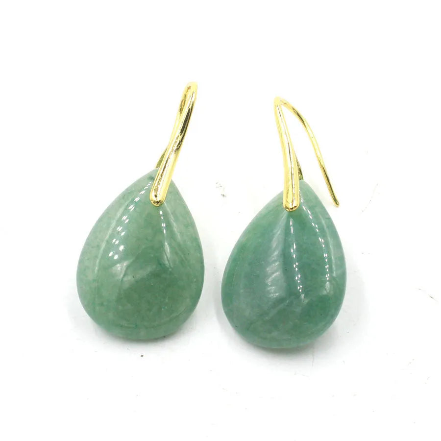 A pair of geometric water drop earrings made from crystal, shown in one of nine available colours like amethyst or obsidian.