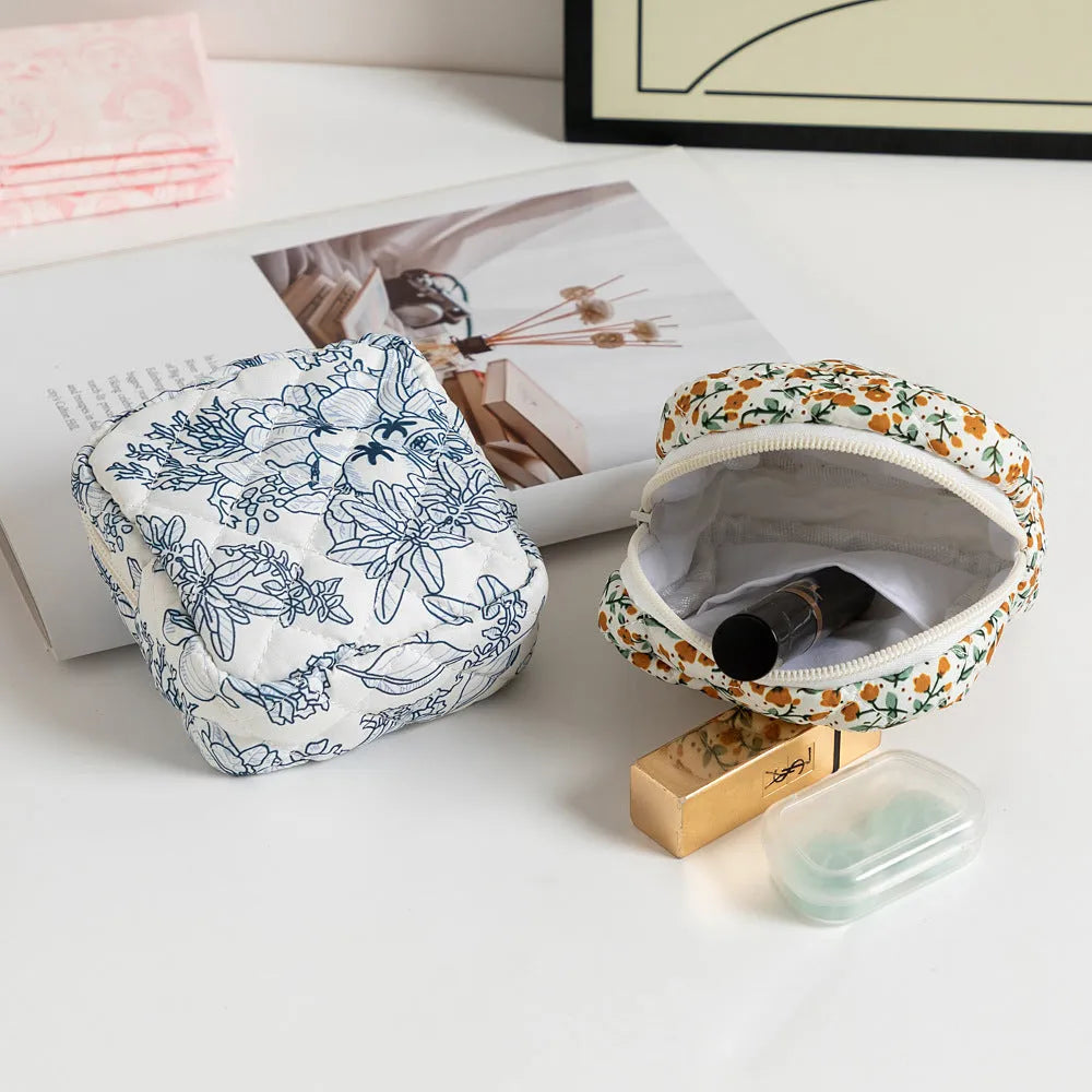 Women's key storage bag in floral polyester with sewing thread details, showing multiple colour and pattern options