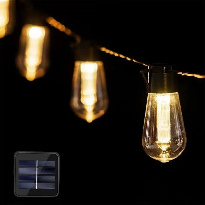 Retro infusion bottle shaped bulb outdoor string lights draped in garden setting