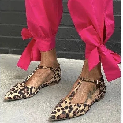 Leopard print women's pumps with pointed toe and low chunky heel featuring cross shoulder straps