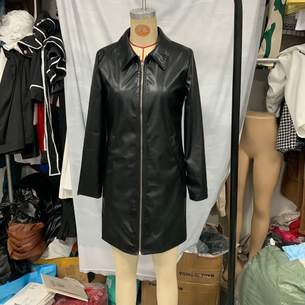 A black medium-length women's leather jacket with long sleeves, laid flat.