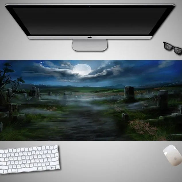 Oversized black Halloween-themed mouse pad with spooky artwork on a desk next to a gaming mouse.
