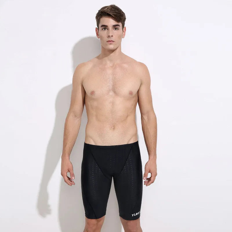 Men's black swimming set including briefs, anti-fog goggles, waterproof cap, ear plug nose clip, and carrying bag