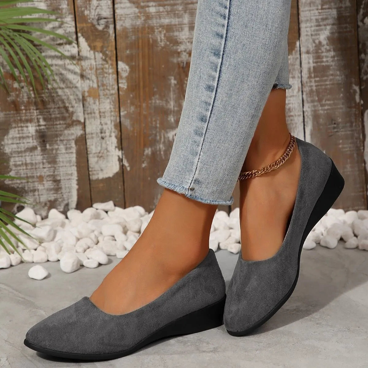 Women's pointed toe wedge pumps in suede with a low heel and shallow mouth opening.