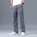 Man wearing light blue loose straight-leg lyocell jeans on a casual background.