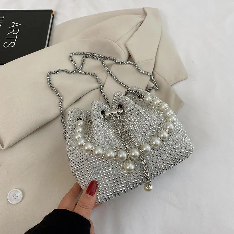 Diamond pattern women's crossbody bag in PU leather with metal chain strap, showing internal phone pocket and change purse.