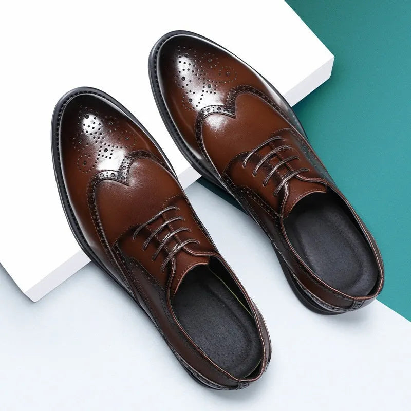 Men's black brogue leather shoes in a business style on a white background.