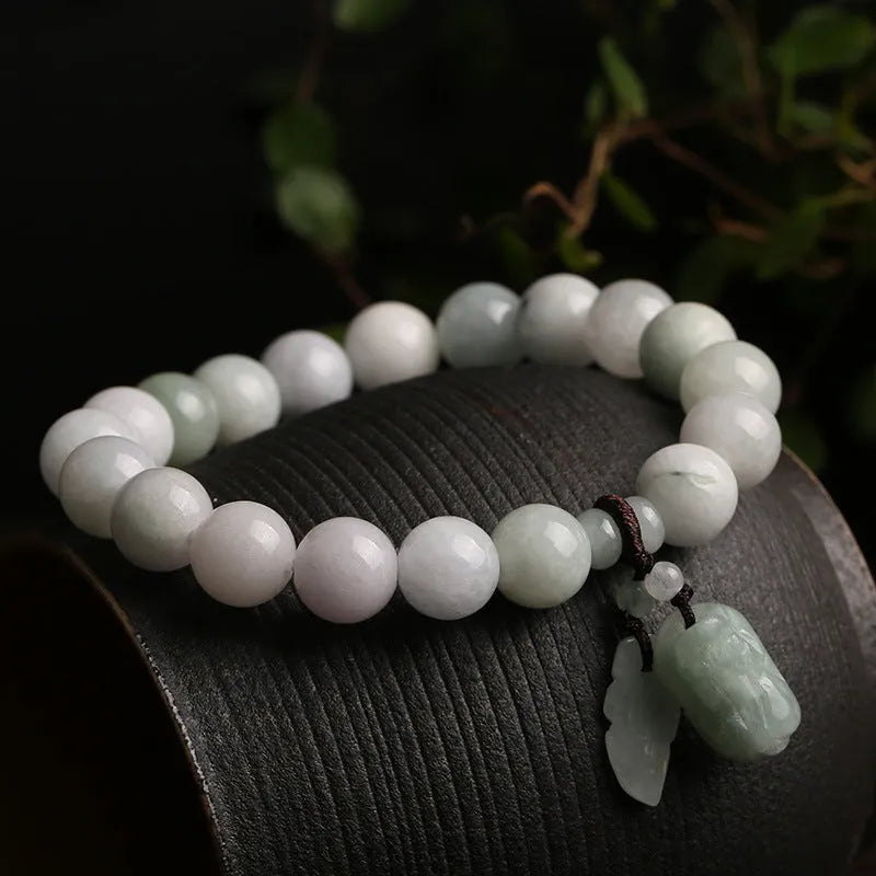 Natural green jade bracelet with geometric links and a carved Maitreya Buddha pendant.