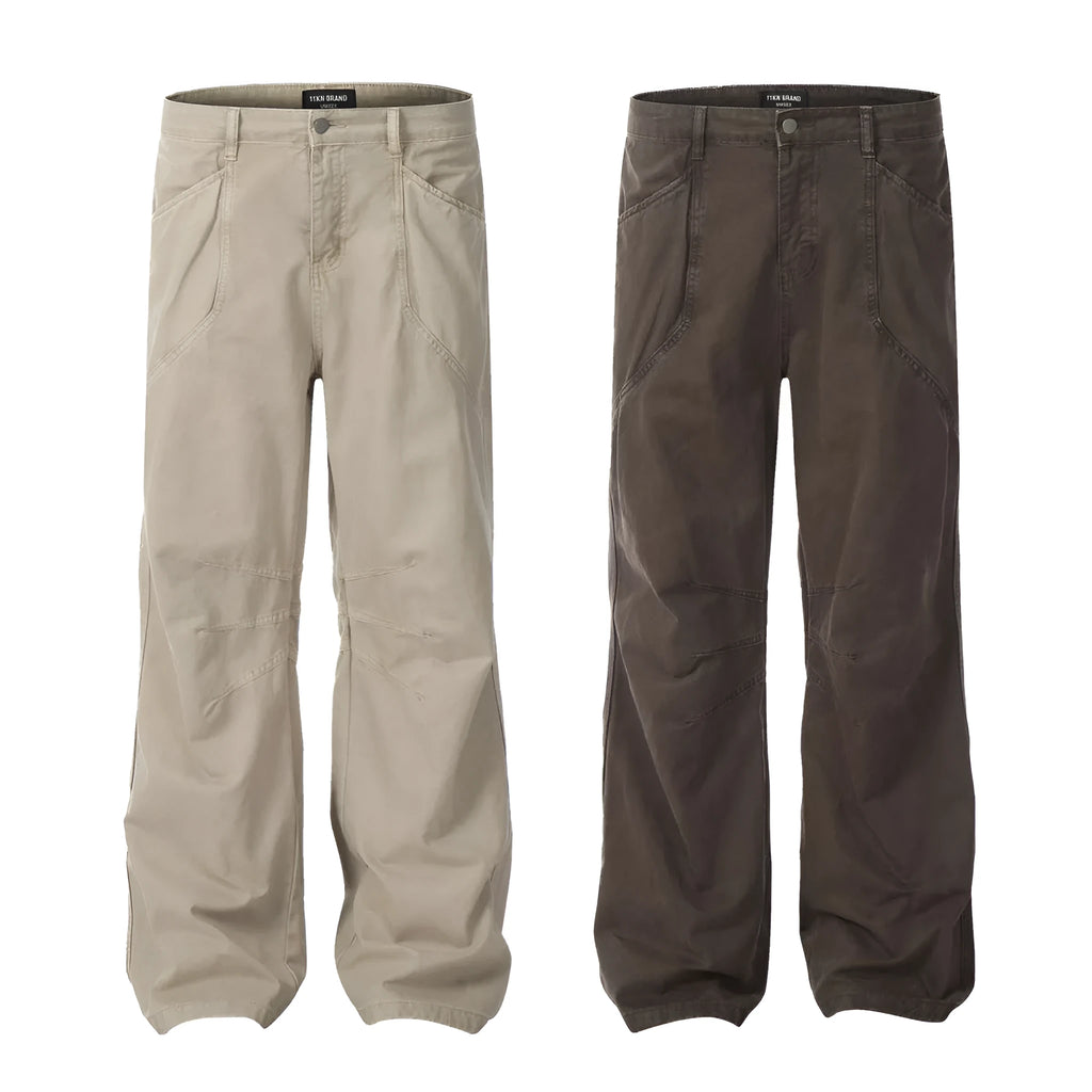Men's brown loose straight leg high waist cotton trousers laid flat.