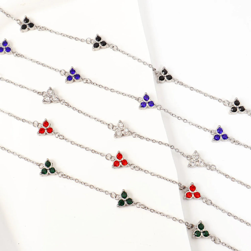 Women's stainless steel geometric bracelet with triangle elements and coloured stone settings