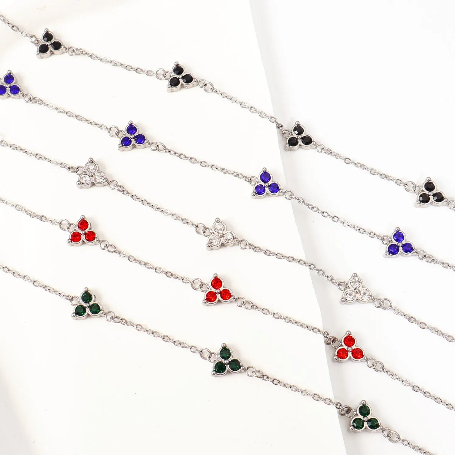 Women's stainless steel geometric bracelet with triangle elements and coloured stone settings